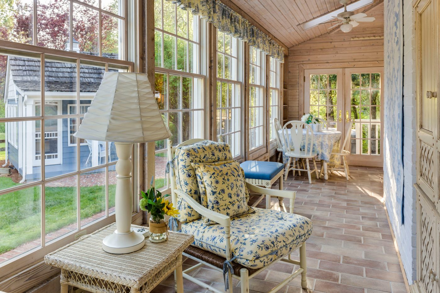 Sunroom addition with floor-to-ceiling windows and wood ceiling
