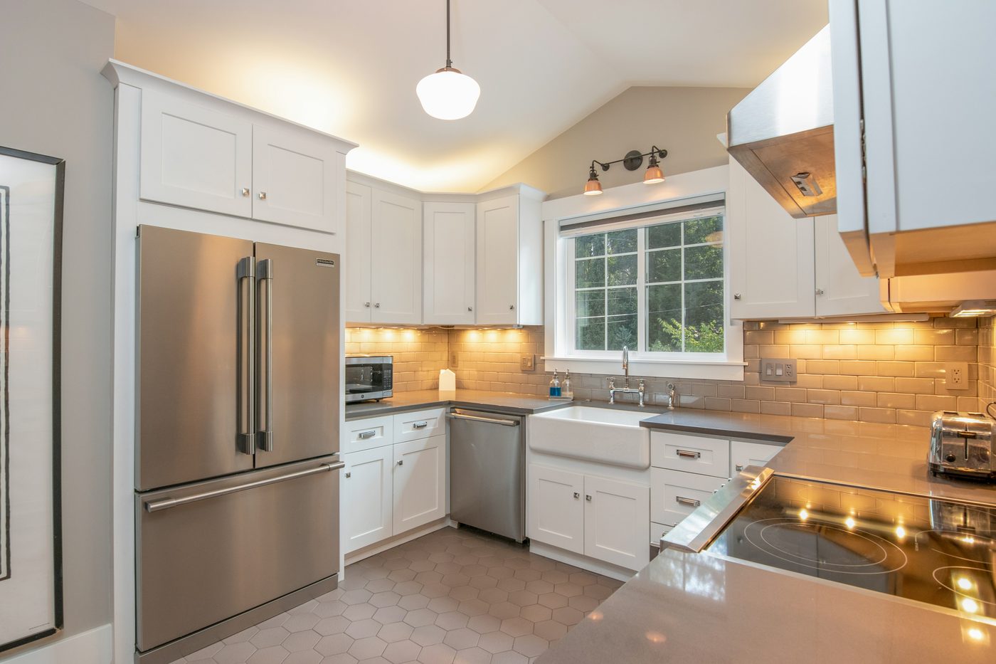 Kitchen remodel with farmhouse sink, under-cabinet lighting, and hex tile floor